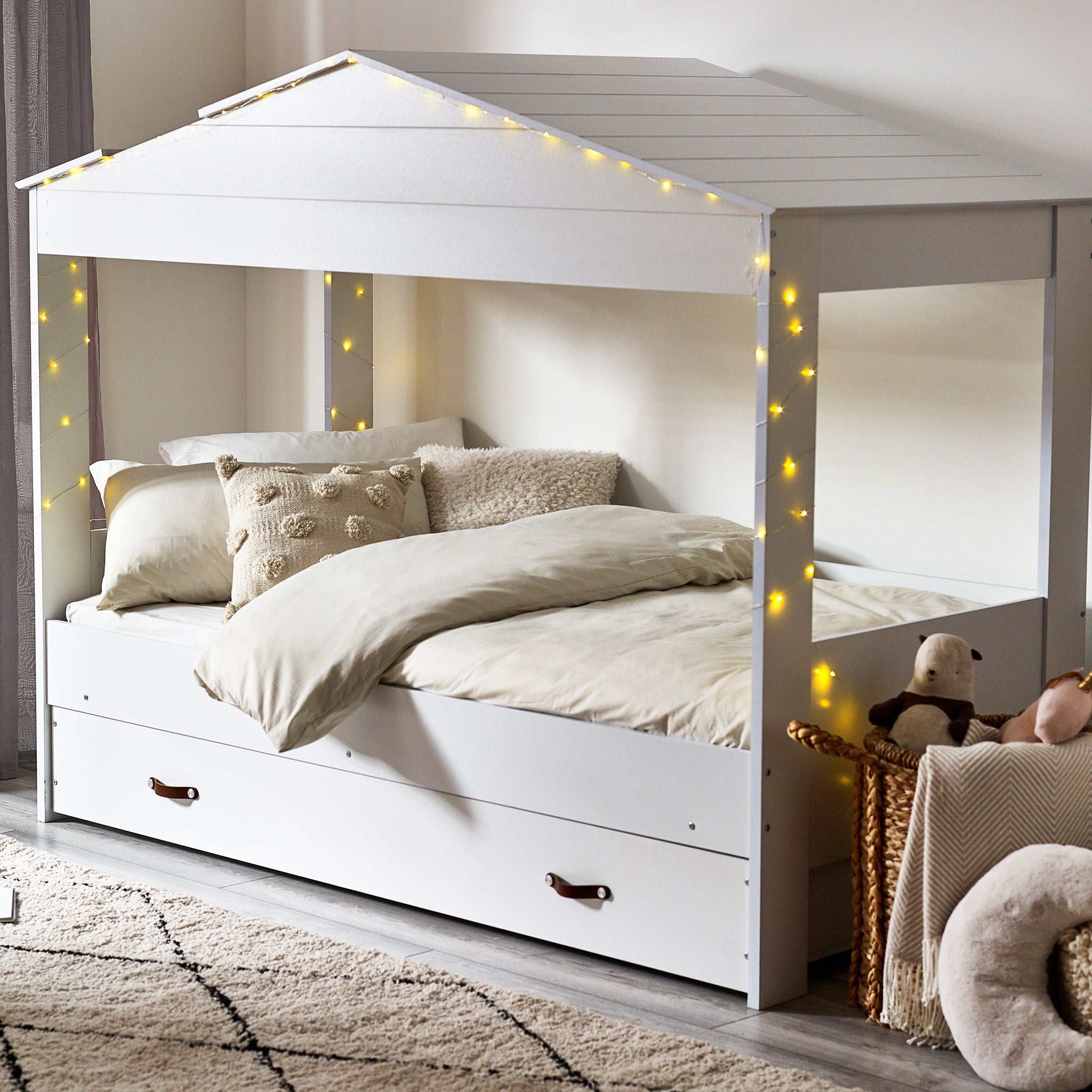 Hut House Low Sleeper – a charming white hut house bed. The paneled roof and inviting gap for stargazing adventures. With a large drawer underneath for storage. Crafted with the safety of your children in mind, two trap handles make it easy for little hands to access their dreamy retreat. Dimensions: D:203 W:100 H:163cm