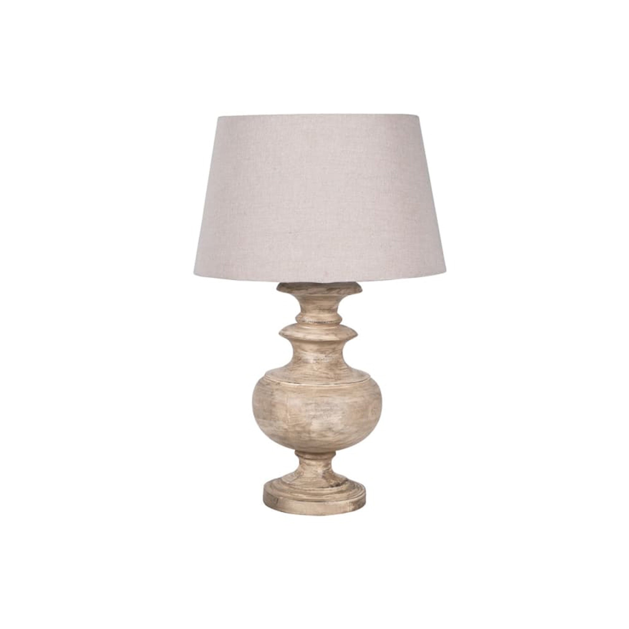 A classic table lamp with a chunky turned wood base in a whitewash finish, and a linen shade