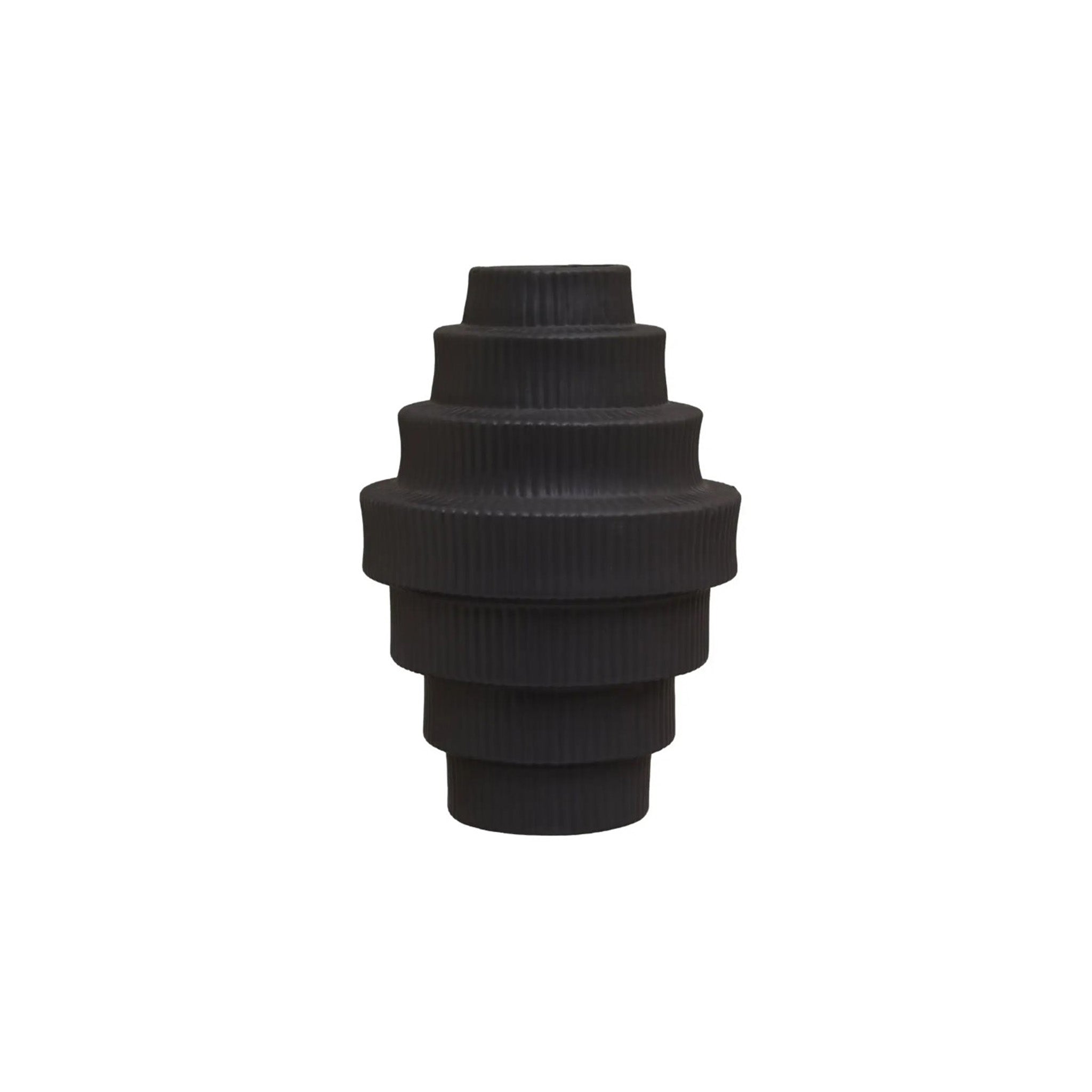 This geometric clean lined vase with a soft ribbed surface, has a minimal stepped angular shape. It is made from ceramic and finished in a matte black shade.  Dimensions: H26 x D18 x W18 cm  Materials: Dolomite  Delivery: 7-10 working days